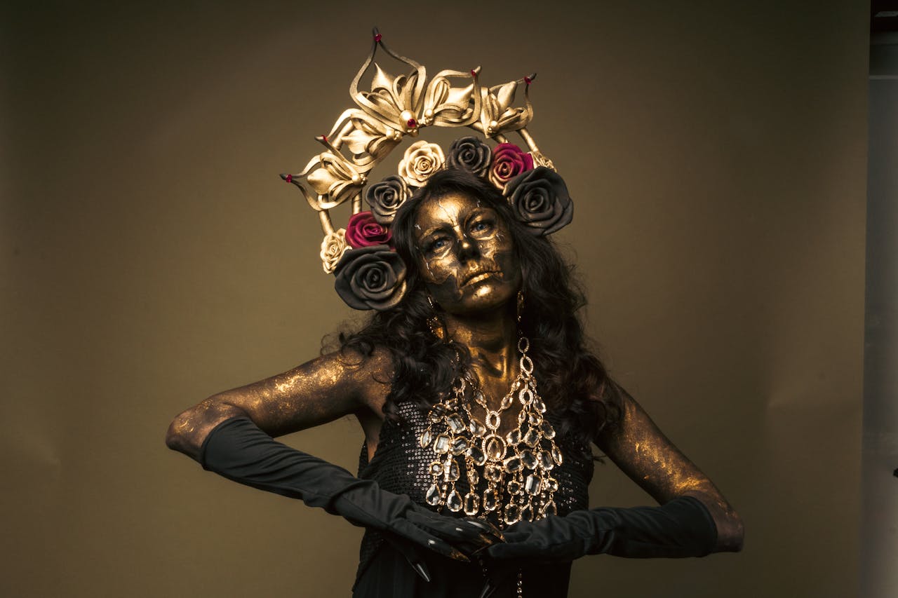 Mesmerizing Catrina model with golden makeup and floral headdress, celebrating Mexican culture.